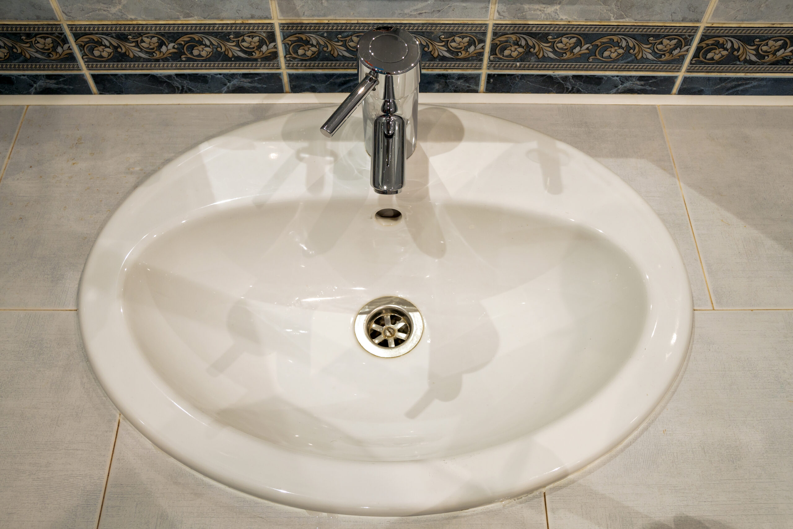 Bathroom interior with sink and faucet valve