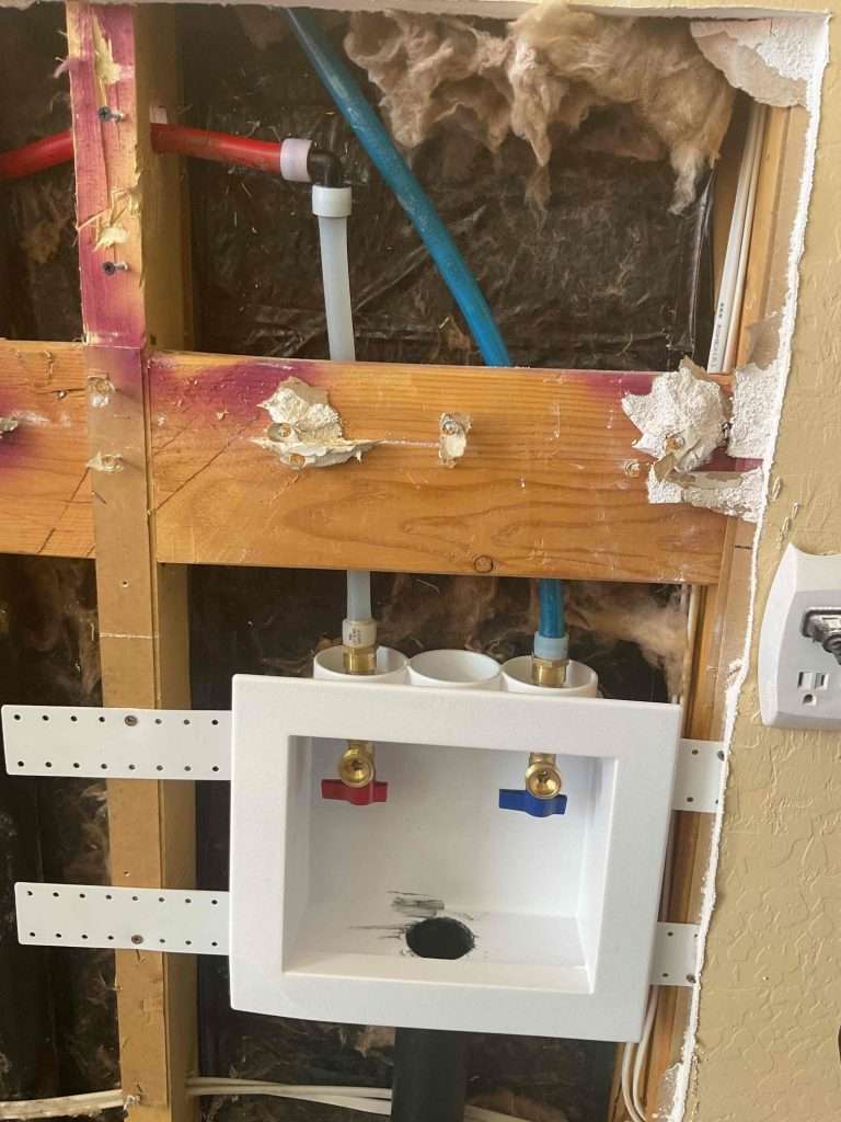 PEX pipes inside a wall after a pipe replacement service.