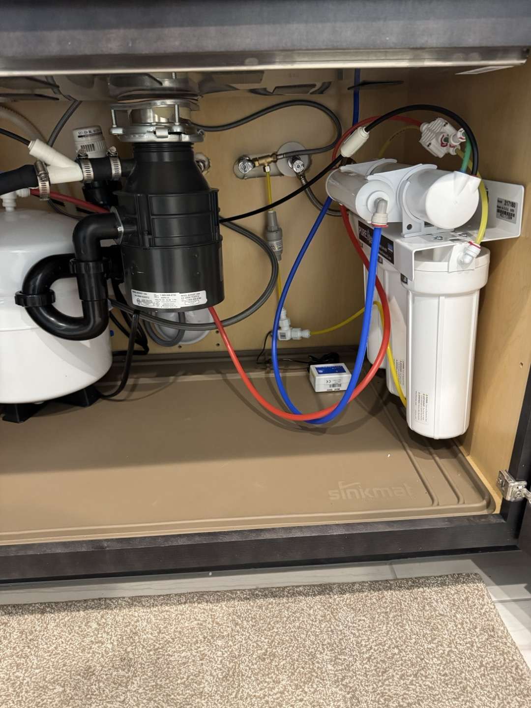 Small water treatment system under the kitchen sink.