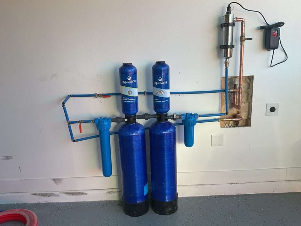 Whole-house water filtration system connected to a pressure tank.
