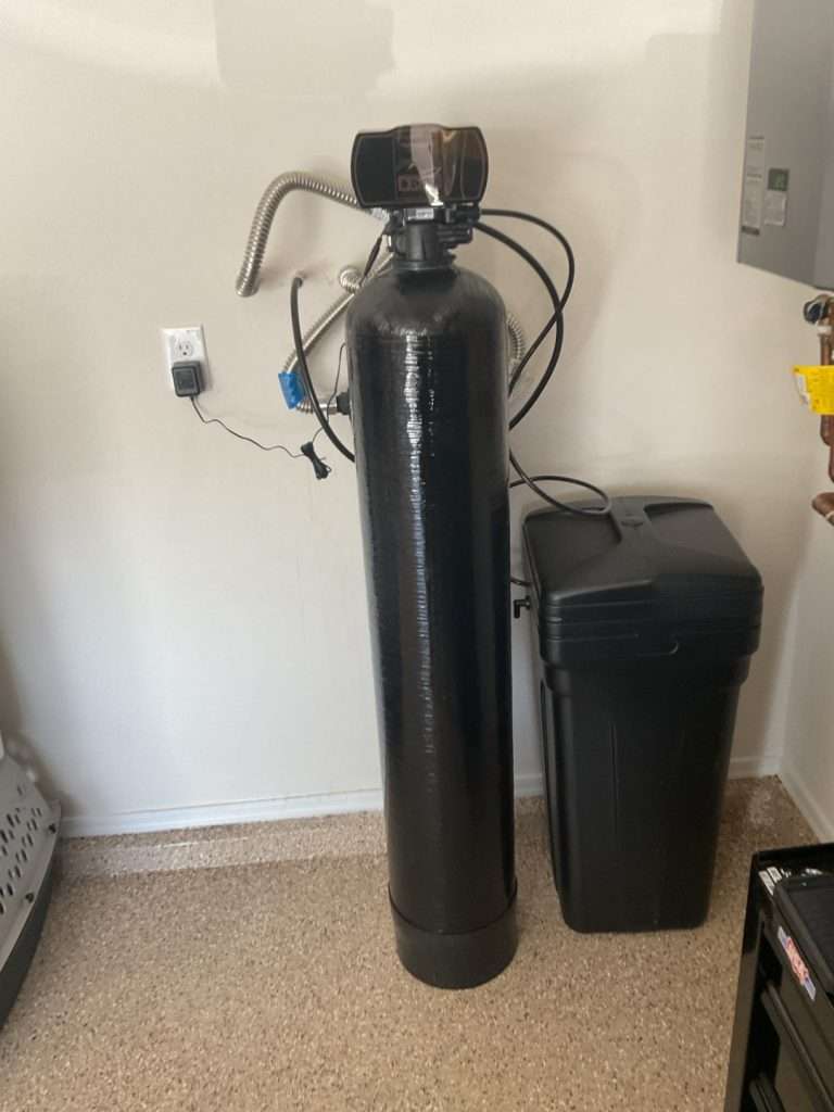 Whole-house water softener system connected to a pressure tank.