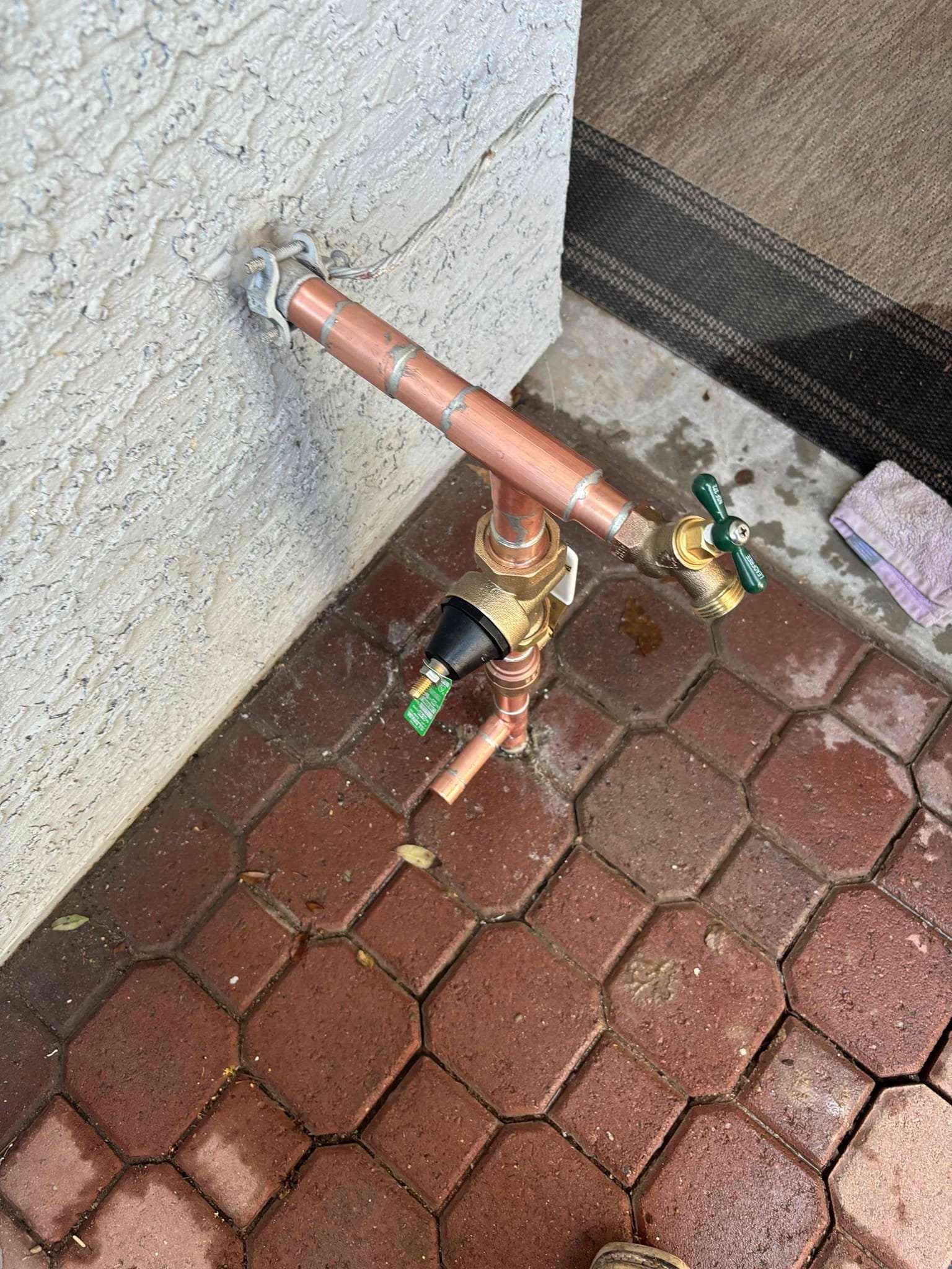 Exterior copper water line after a repair service.