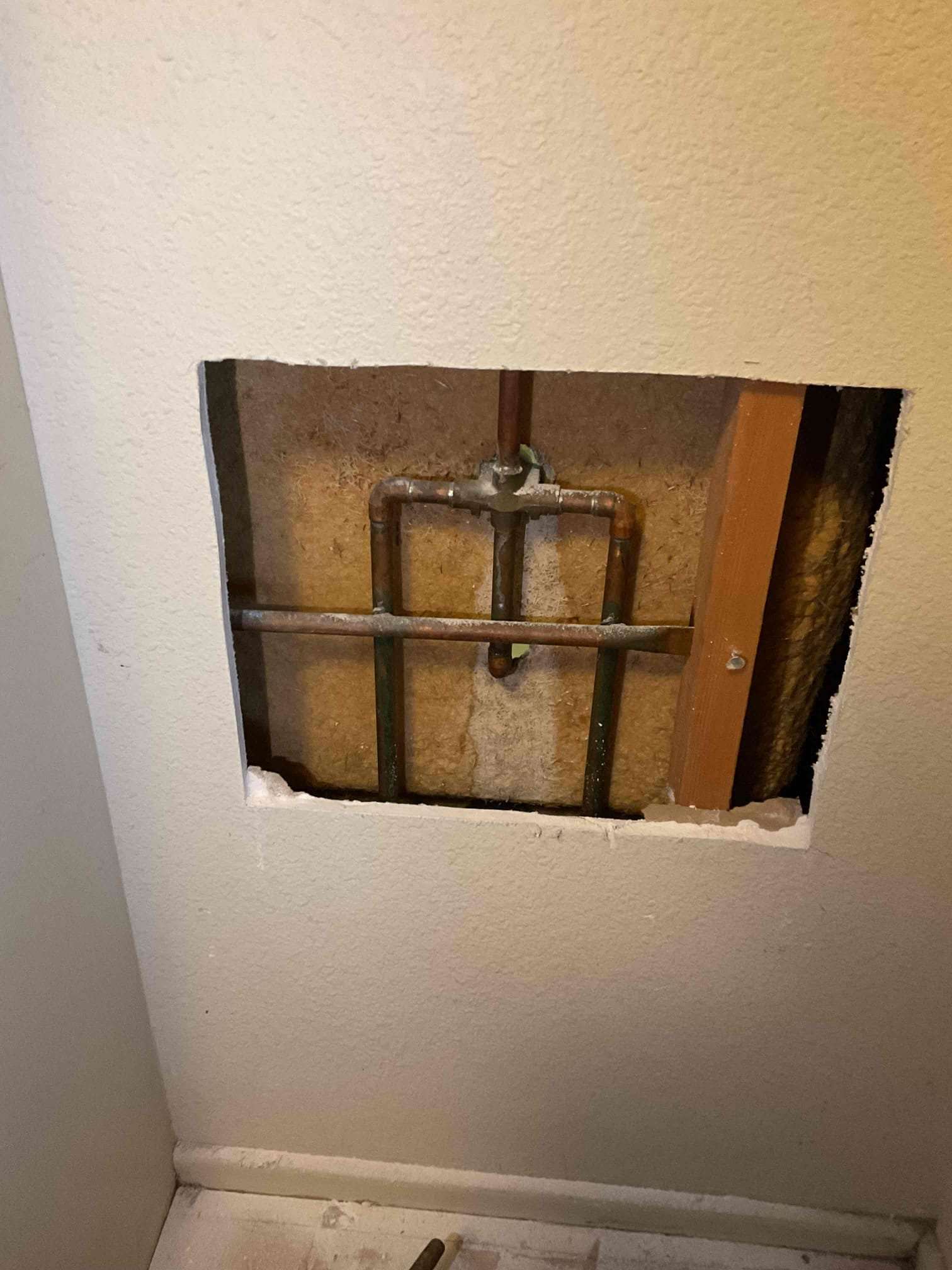 Copper pipe inside wall after a water leak repair service.